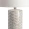 cylindrical white ceramic body features a pattern made of small fish touching head to tail